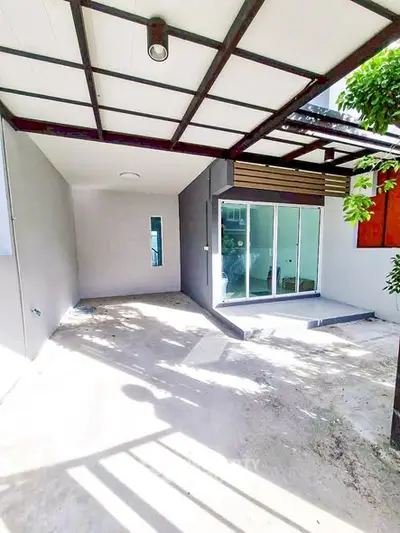 Modern covered patio with sliding glass doors and ample natural light