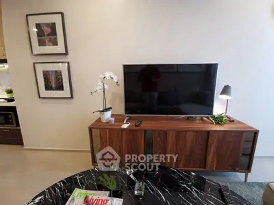 Modern living room with sleek TV stand, wall art, and elegant decor