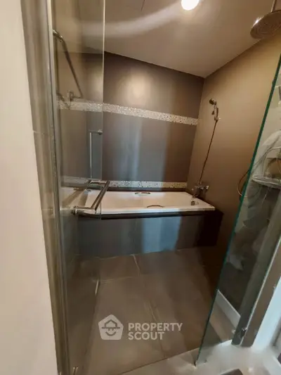 Modern bathroom with sleek bathtub and glass shower enclosure