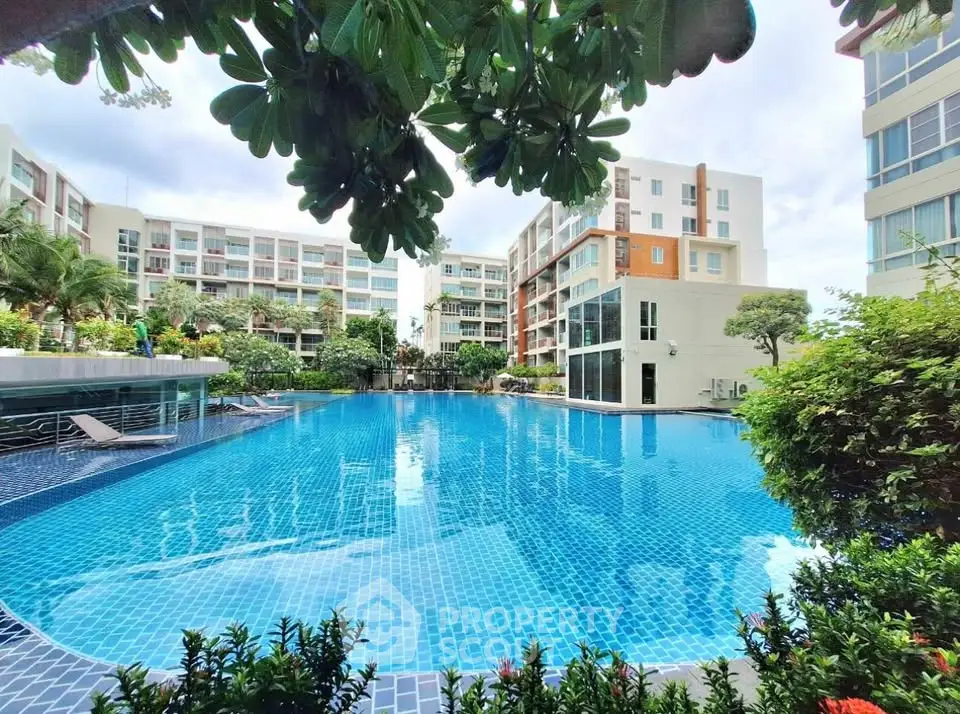 Luxurious condominium with stunning pool and lush greenery, perfect for relaxation and leisure.