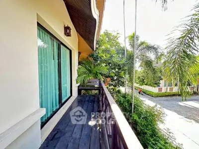 Charming balcony with lush greenery and serene neighborhood view