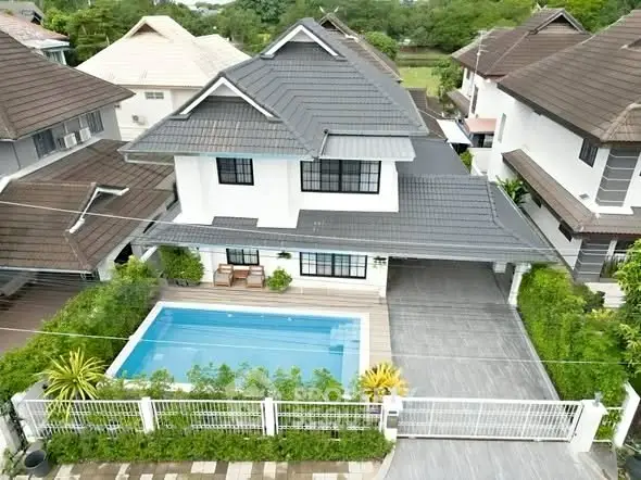 Stunning two-story house with private pool and lush garden in a serene neighborhood.