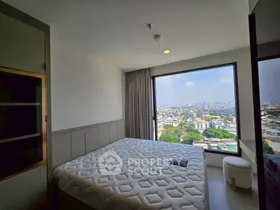 Spacious bedroom with panoramic city view from large window