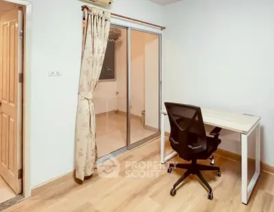 Modern study room with sleek desk and ergonomic chair, featuring sliding glass doors and elegant curtains.