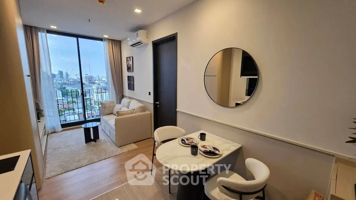 Modern living room with city view, featuring elegant decor and open layout for a cozy ambiance.