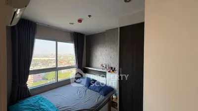 Cozy bedroom with large window offering stunning city view