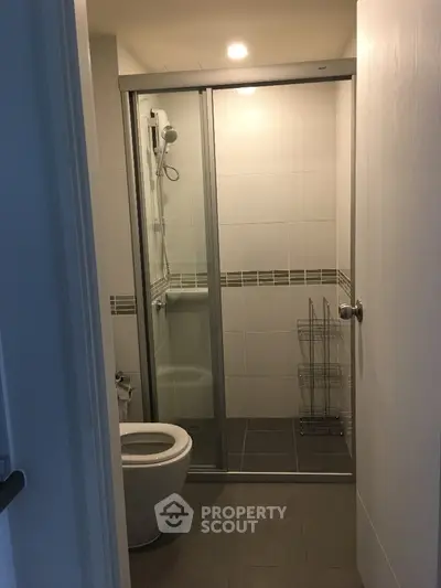 Modern bathroom with glass shower enclosure and sleek tile design