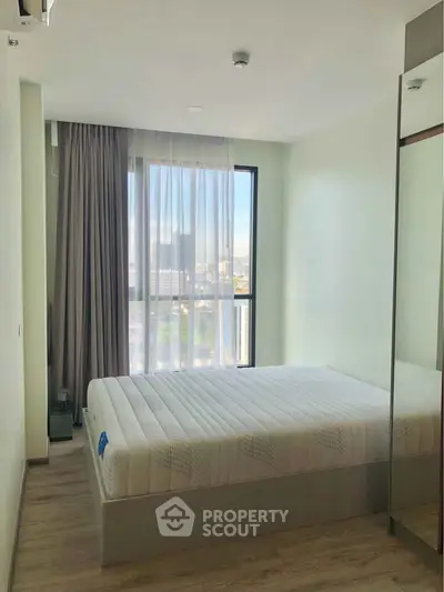 Modern bedroom with large window and minimalist decor