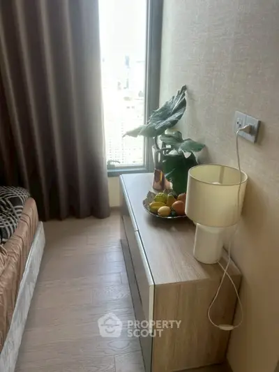 Cozy bedroom corner with modern decor and city view window