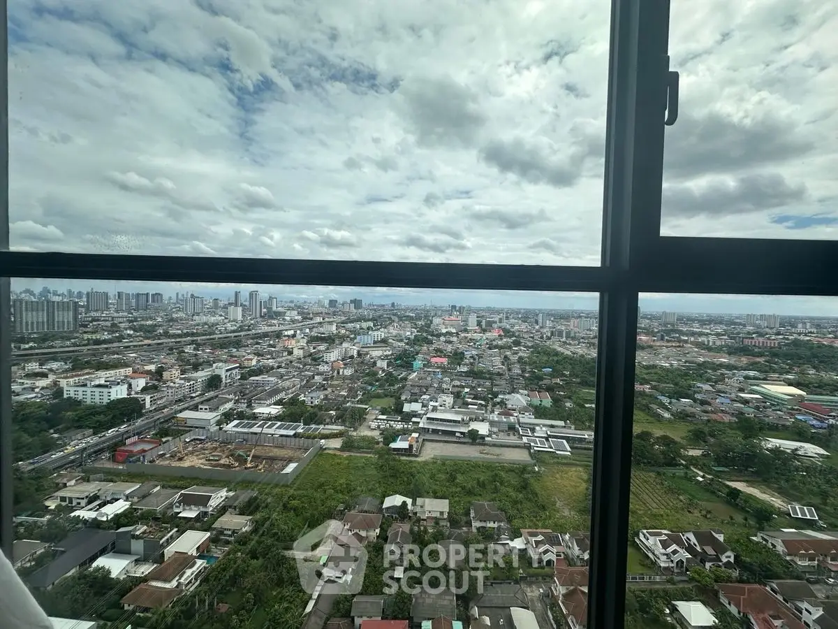 Stunning cityscape view from high-rise window showcasing urban landscape and skyline.