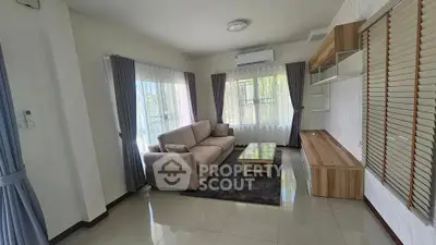 Spacious living room with modern furnishings and large windows for natural light.