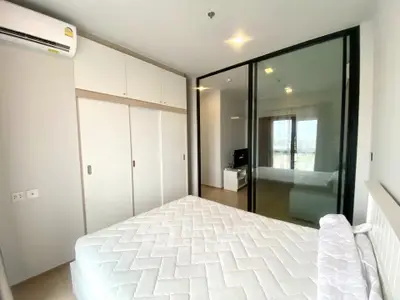 Modern bedroom with large glass sliding doors and built-in wardrobe