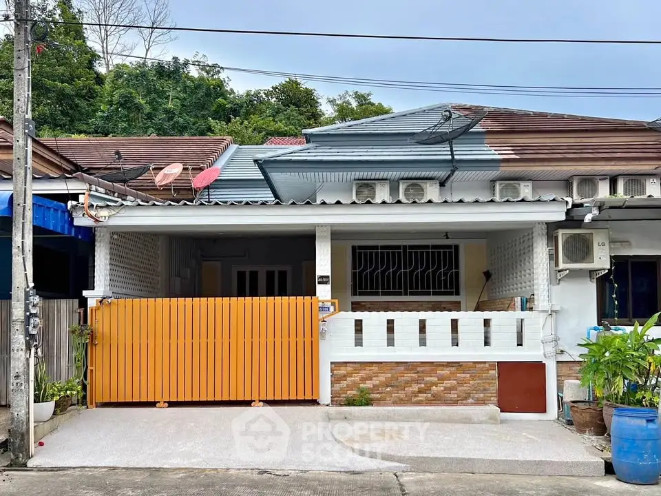 Charming single-story home with a gated front patio and modern exterior design.