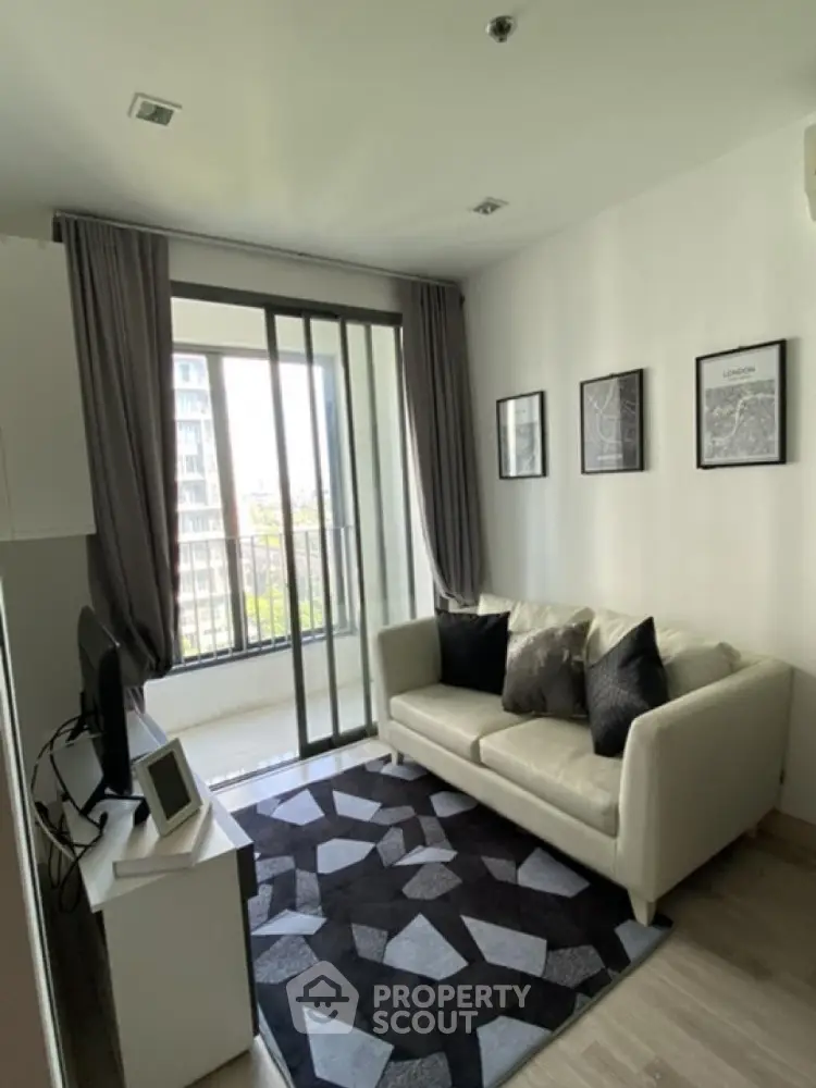 Modern living room with stylish decor and balcony view in urban apartment