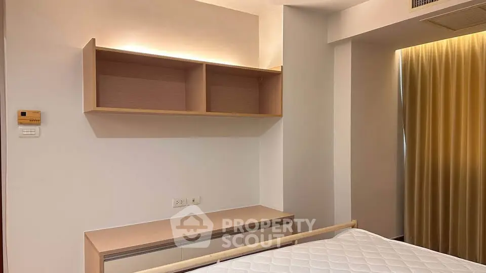 Modern bedroom with built-in shelves and cozy lighting