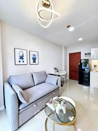 Modern living room with stylish decor and sleek furniture in a bright apartment.
