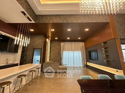 Luxurious modern living room with elegant lighting and open kitchen layout