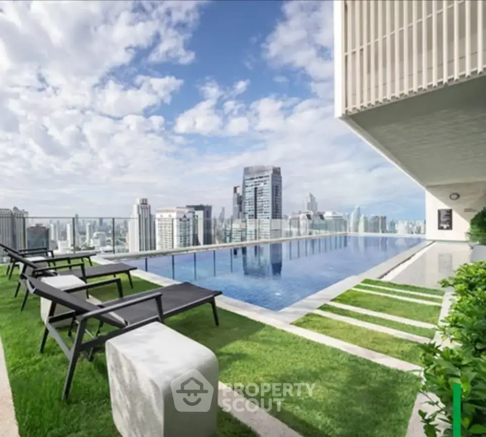 Luxurious rooftop pool with stunning city skyline views and modern seating area.