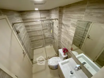 Modern bathroom with glass shower and sleek fixtures