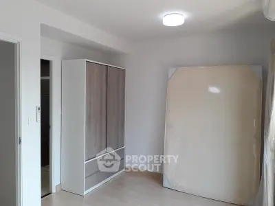 Minimalist bedroom with wardrobe and mattress in modern apartment