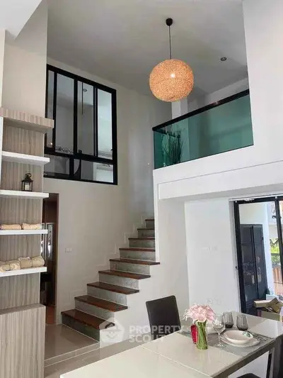 Modern open-plan living space with mezzanine and stylish decor
