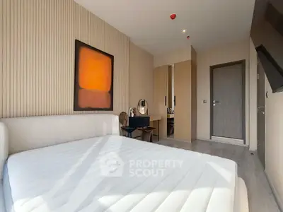 Modern bedroom with minimalist design and large window for natural light.