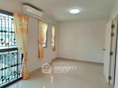Bright empty room with air conditioning and tiled floor