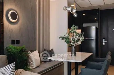 Modern living room with stylish decor and dining area, featuring elegant lighting and contemporary furniture.