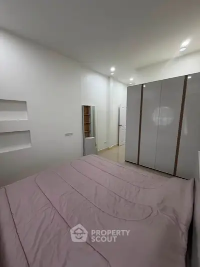 Modern bedroom with sleek wardrobe and minimalist design