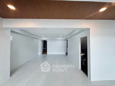 Spacious modern living room with sleek design and recessed lighting