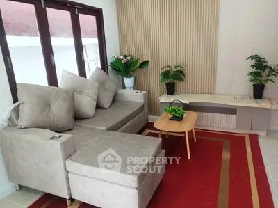 Cozy living room with modern beige sofa and stylish decor