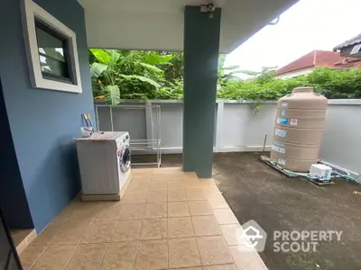 Charming outdoor laundry area with washing machine and lush greenery view