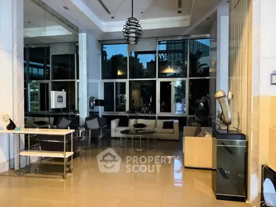 Luxurious modern living room with elegant decor and large windows offering a stunning view.