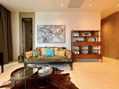 Luxurious living room with elegant decor and stylish furniture, featuring a cozy sofa and modern shelving unit.