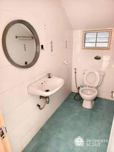 Compact bathroom with modern fixtures and blue tile flooring