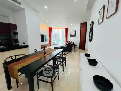 Modern open-plan living and dining area with city view, featuring sleek furniture and elegant decor.
