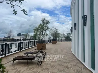 Spacious rooftop terrace with lounge chairs and city views, perfect for relaxation and entertainment.