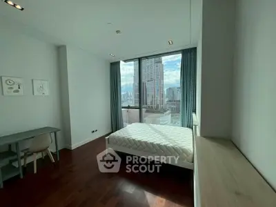 Modern bedroom with city view, featuring a minimalist design and large window for natural light.