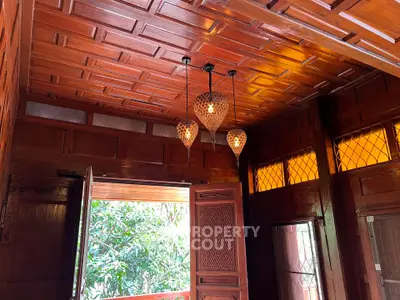 Charming wooden interior with intricate ceiling and warm lighting, perfect for a cozy living space.