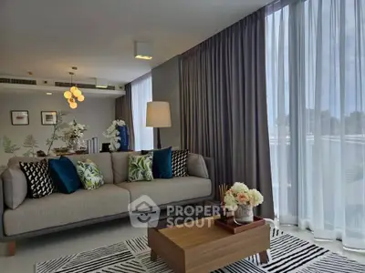 Modern living room with stylish decor and large windows for natural light.