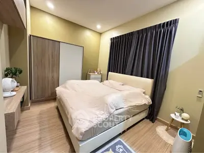 Cozy bedroom with modern decor and ample natural light