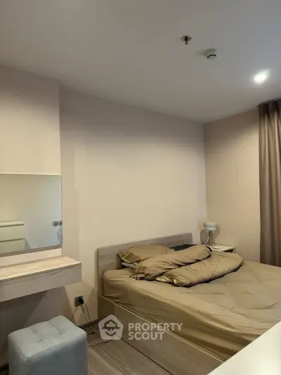 Cozy bedroom with modern decor and neutral tones, featuring a comfortable bed and stylish furnishings.