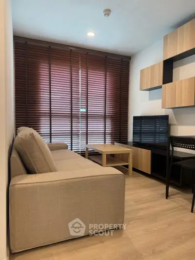 Modern living room with stylish furniture and wooden blinds, perfect for cozy relaxation.