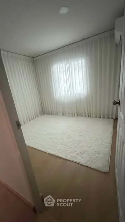 Spacious empty bedroom with soft carpet and elegant curtains