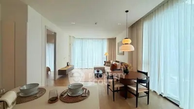 Spacious modern living room with dining area and large windows in a stylish apartment.