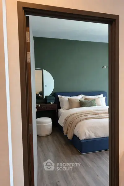 Elegant bedroom with modern decor and cozy bedding in a stylish apartment.