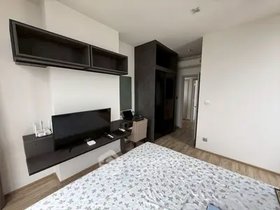 Modern bedroom with sleek furniture and built-in workspace