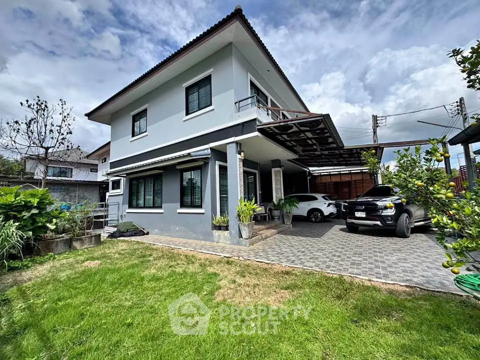 Charming two-story house with spacious driveway and lush garden, perfect for family living.