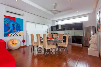 Modern dining room with elegant decor and open kitchen layout, featuring sleek appliances and stylish furnishings.