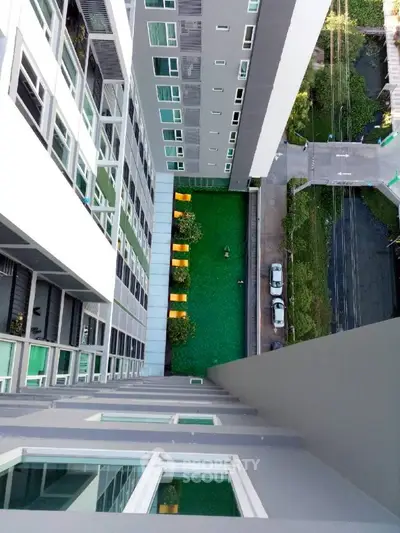 High-rise building with green courtyard view from above